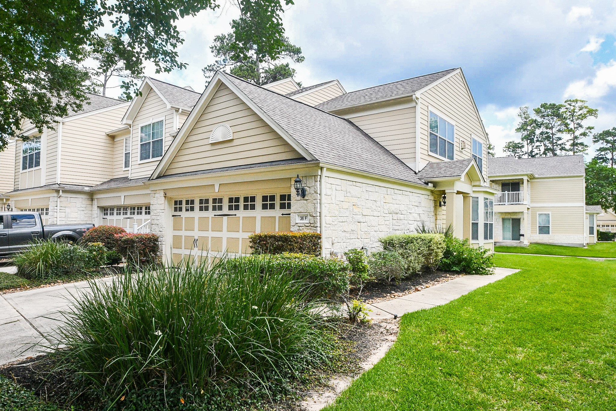 13600 Breton Ridge Street, Unit 36F Houston, TX 77070 - Photo 1 of 38 Charming exterior with mature landscaping and inviting curb appeal.
