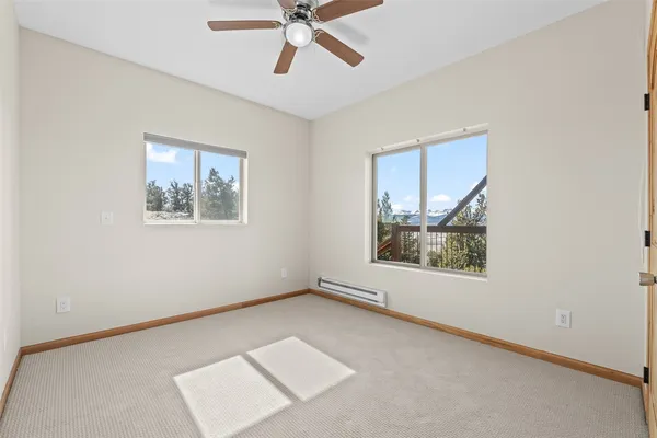 a view of an empty room window and wooden floor