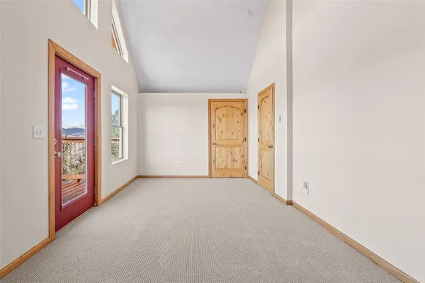 an empty room with windows and closet