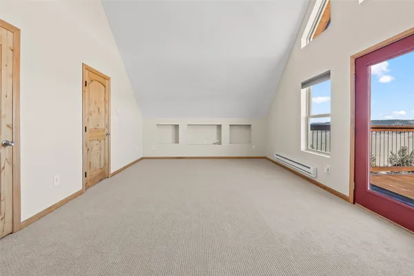 an empty room with windows and closet