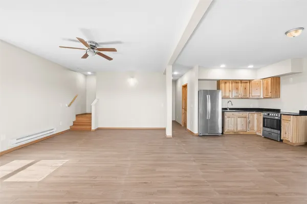 a view of a kitchen with a sink and a refrigerator