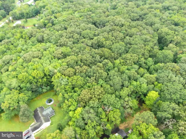 an aerial view of a house with yard