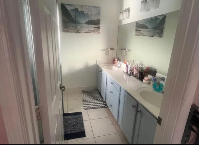 a bathroom with a double vanity sink and mirror