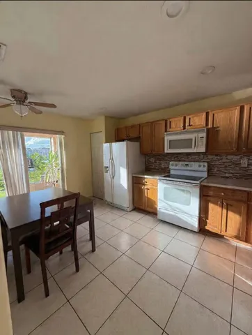 a kitchen with stainless steel appliances a stove a sink and a refrigerator