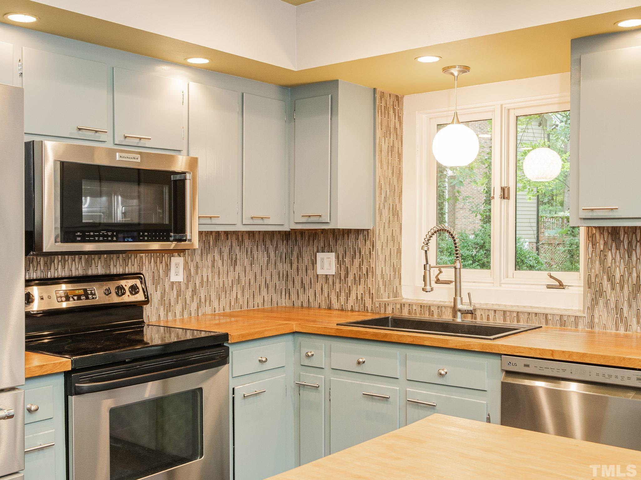 3116 Paxton Place Raleigh, NC 27613 - Photo 48 of 67 a kitchen with a sink stove and microwave