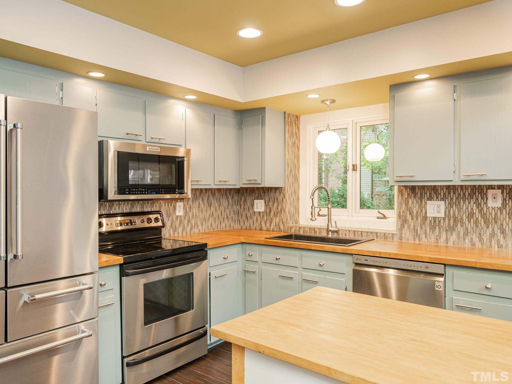 3116 Paxton Place Raleigh, NC 27613 - Photo 50 of 67 a kitchen with a sink stove and microwave