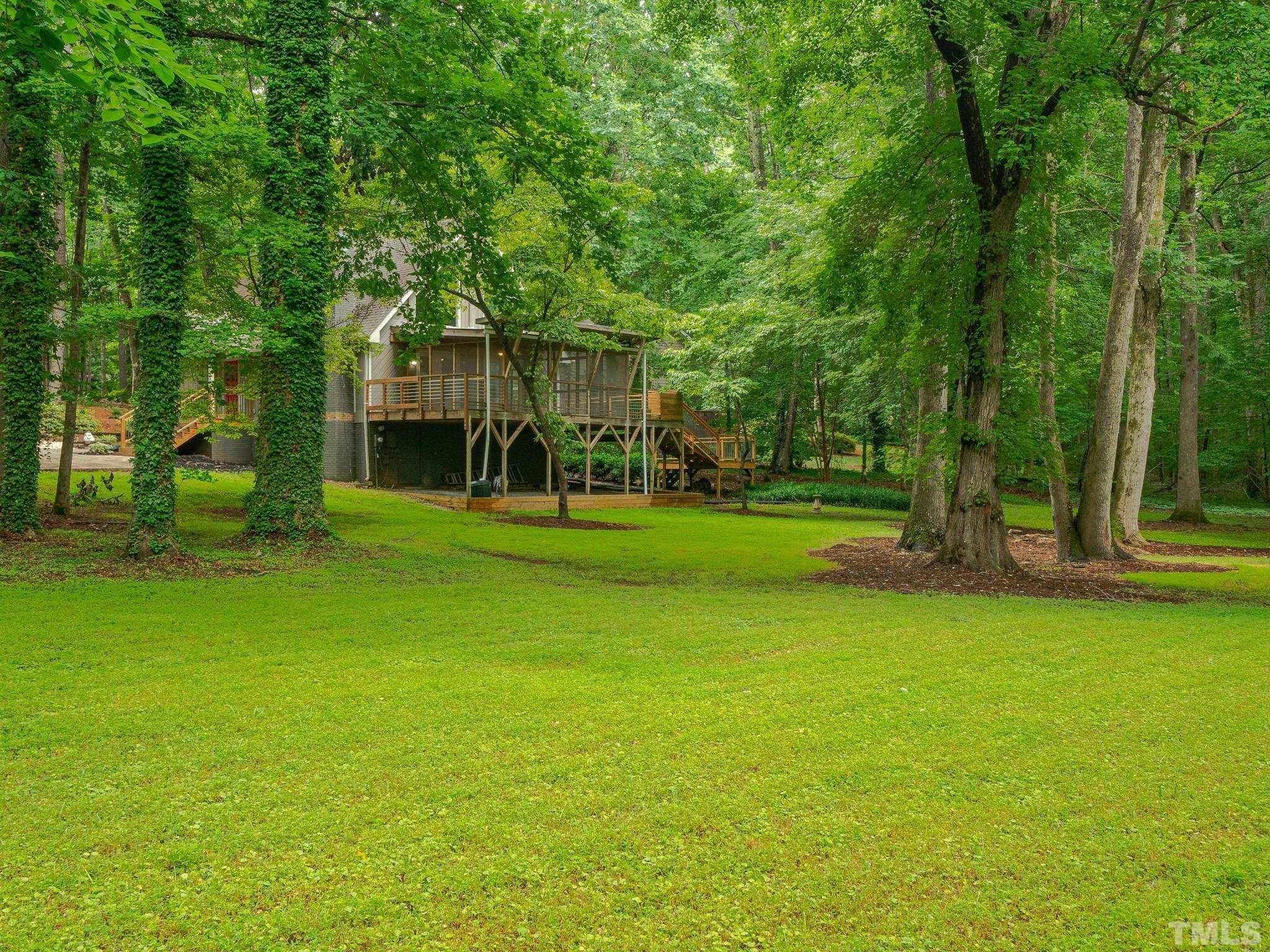3116 Paxton Place Raleigh, NC 27613 - Photo 5 of 67 a backyard of a house with lots of green space and fountain