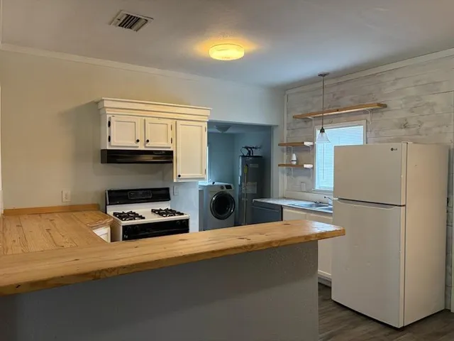 a kitchen with refrigerator and cabinets