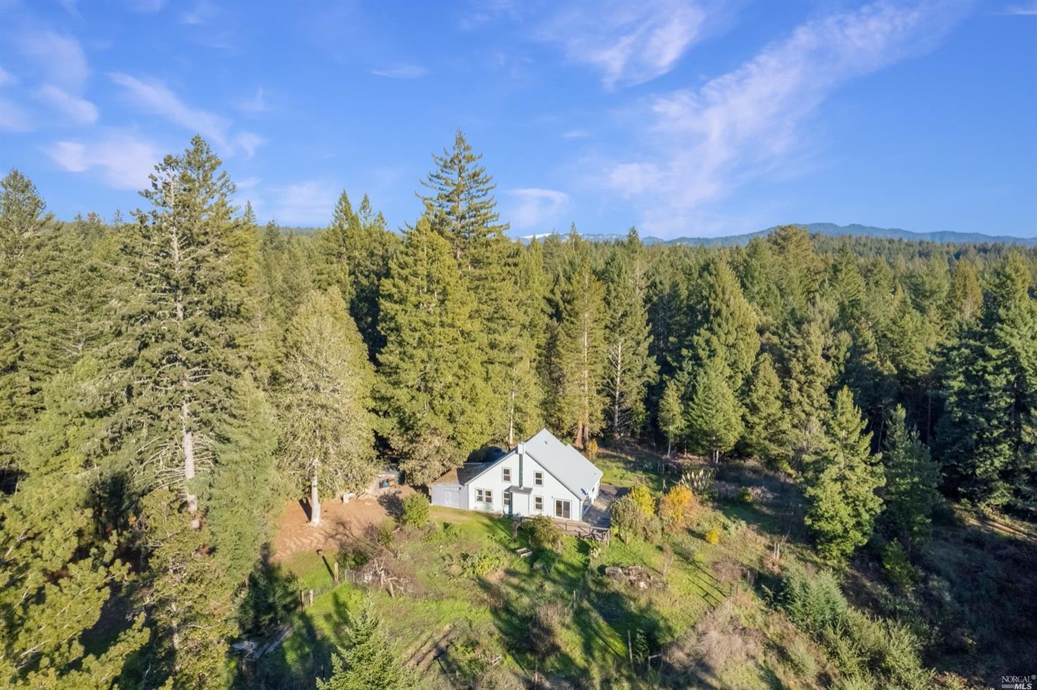 43155 Brushy Ridge Loop Annapolis, CA 95412 - Photo 1 of 1 a view of a lake with a building in the background