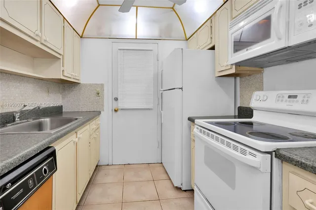 a kitchen with a sink cabinets and stainless steel appliances