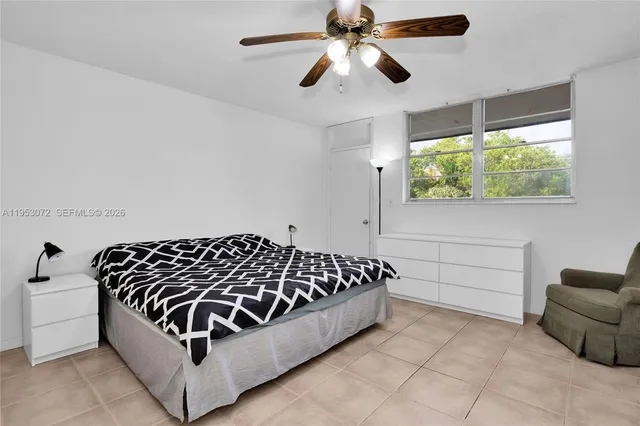 a bathroom with a bathtub and a chandelier