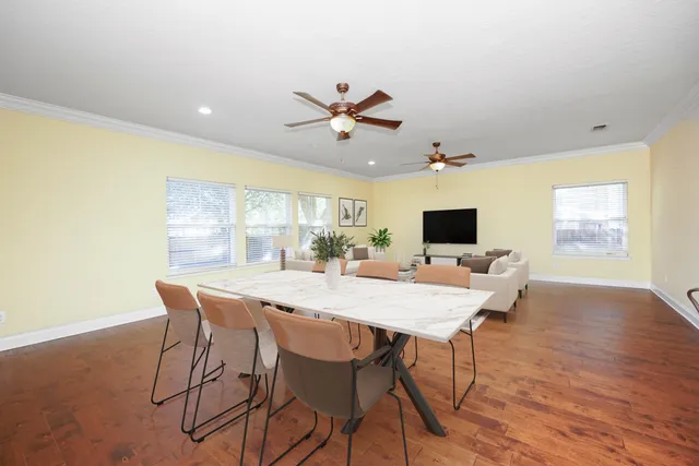 a view of a dining room with furniture window and wooden floor