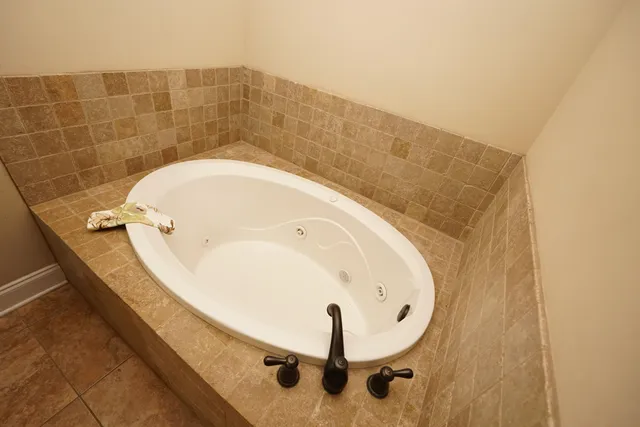 a bathroom with a tub and mirror