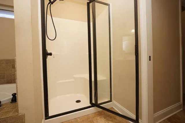 a view of a bathroom with a glass shower door