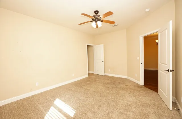 a view of a big room with a ceiling fan