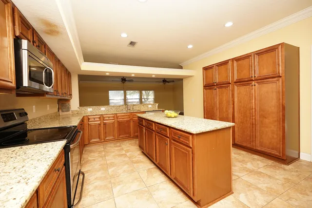 a kitchen with stainless steel appliances granite countertop a stove and a refrigerator