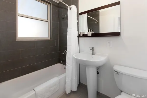 a bathroom with a sink a toilet and a bathtub