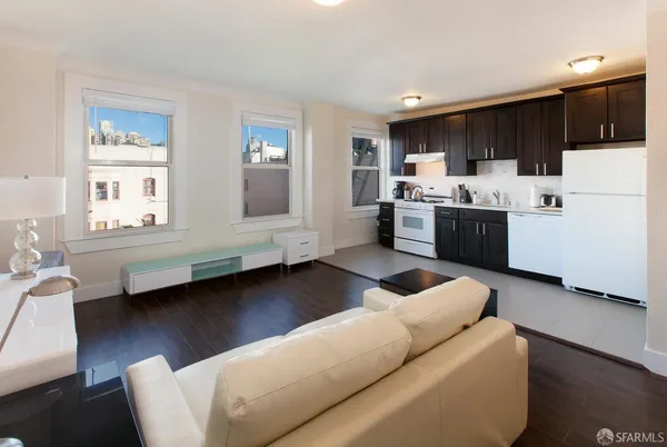 a living room with furniture and kitchen view