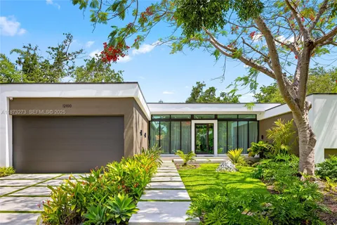 a bedroom with a bed and a potted plant