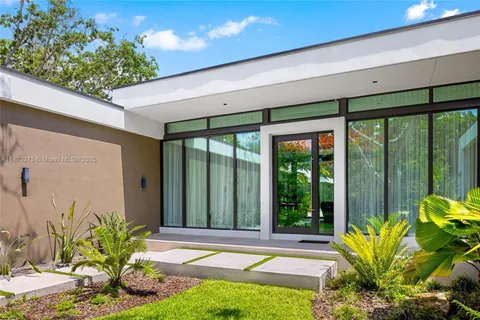 a kitchen with stainless steel appliances granite countertop a sink a stove a refrigerator and island with wooden floor