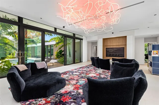 a living room with furniture couches and a large window