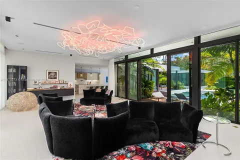 a living room with furniture and floor to ceiling window
