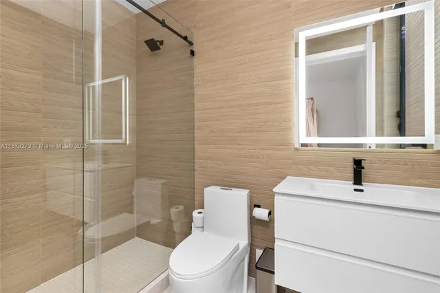 an aerial view of a house with a yard and lake view