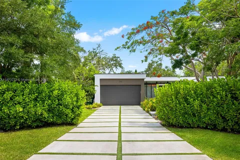 a front view of a house with a garden