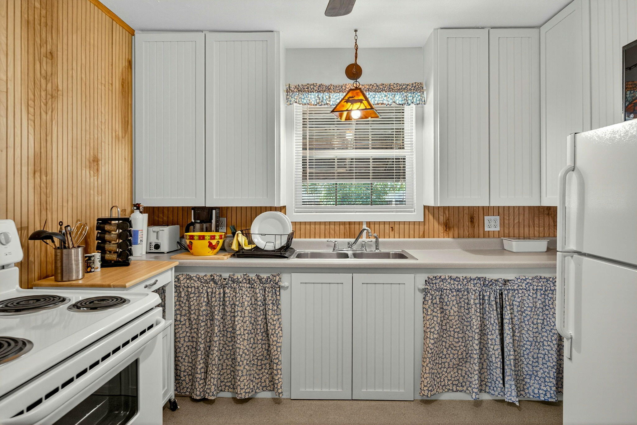 1176 Hamilton Road Jacksonville, OR 97530 - Photo 51 of 125 a kitchen with a sink a stove cabinets and a window