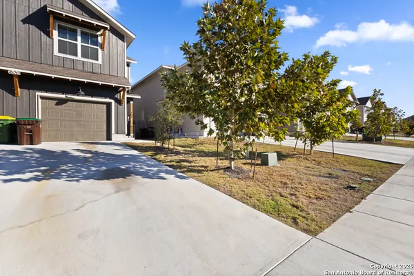a view of a house with snow on the road