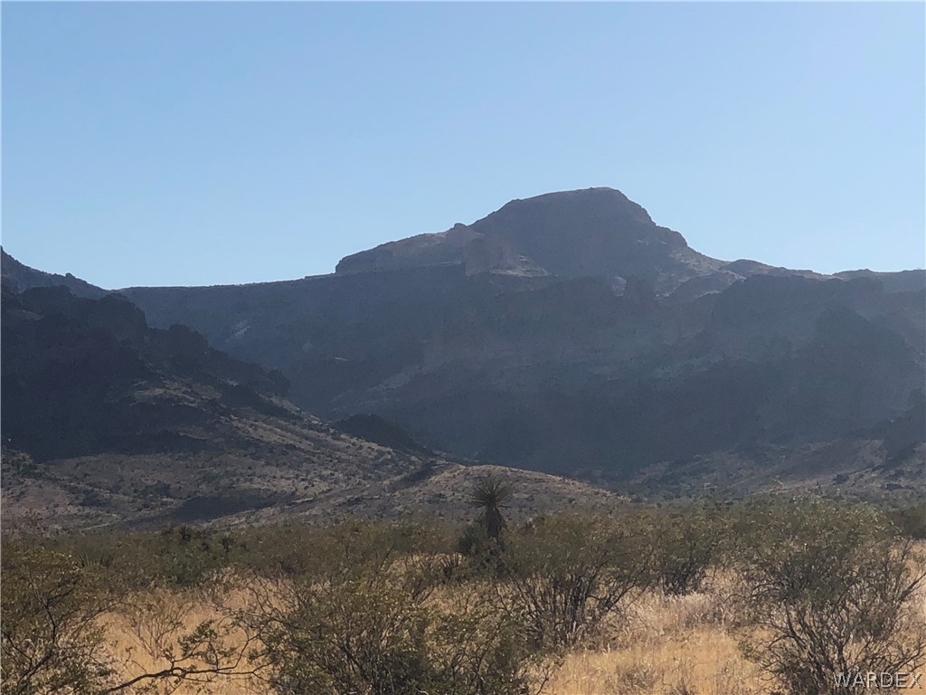 3596 Naco Road Golden Valley, AZ 86413 - Photo 1 of 3 a view of a dry yard with mountains in the background