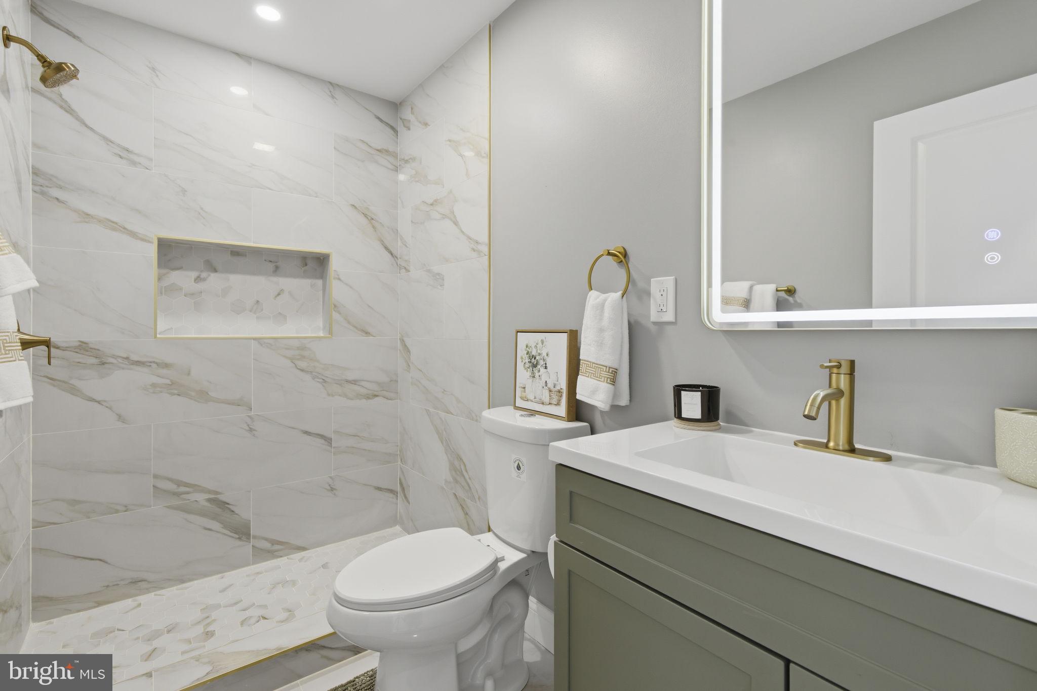 1600 Federal Street Baltimore, MD 21213 - Photo 21 of 31 a bathroom with a sink a toilet and a mirror