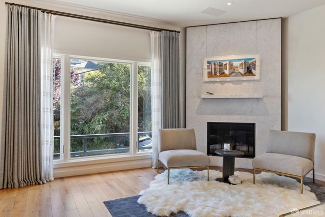 a kitchen with a stove a sink a kitchen island with wooden cabinets and floor