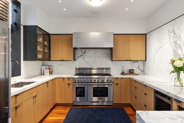 a kitchen with a table chairs and white cabinets