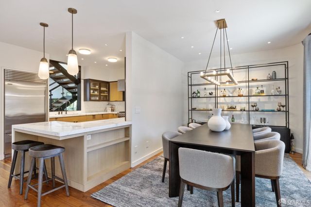 a view of a kitchen with a sink wooden floor and a window