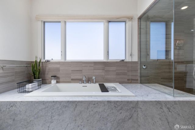 a balcony with furniture and a potted plant