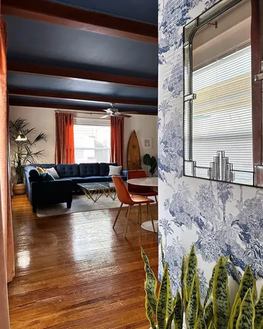 a living room filled with furniture window and wooden floor