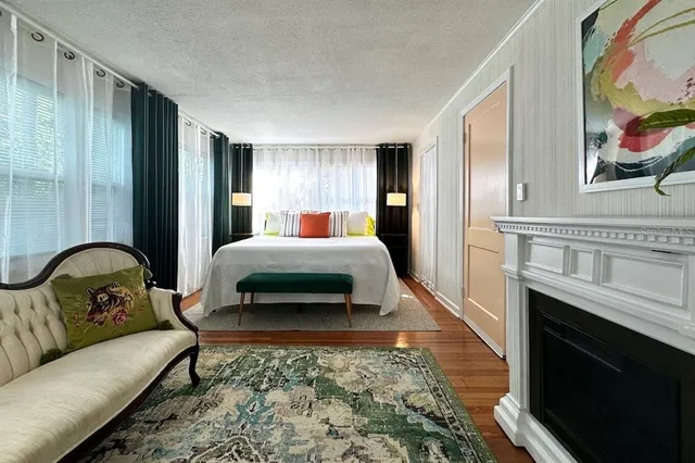 a bedroom with a bed couch and a stove