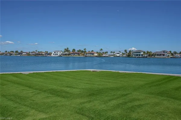 a view of a field with an ocean