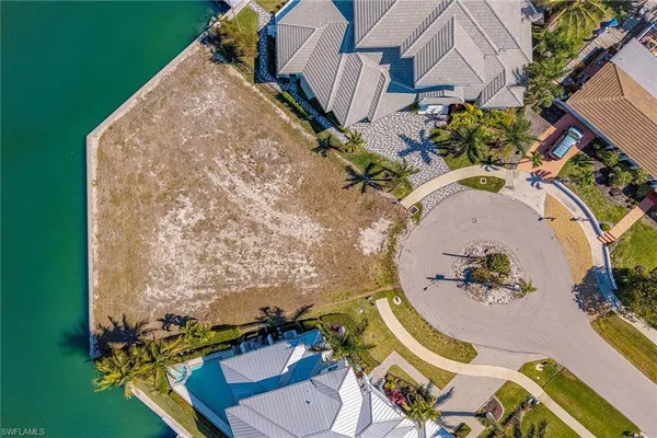 an aerial view of a house with a swimming pool and outdoor seating