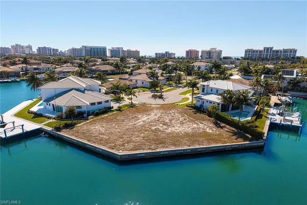an aerial view of a house with a garden and lake view
