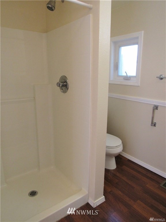 2212 Broadway Everett, WA 98201 - Photo 20 of 26 a white toilet sitting next to a shower