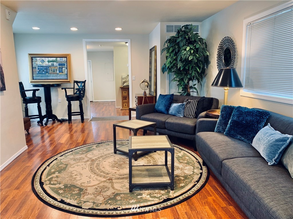 2212 Broadway Everett, WA 98201 - Photo 7 of 26 a living room with furniture and a chandelier