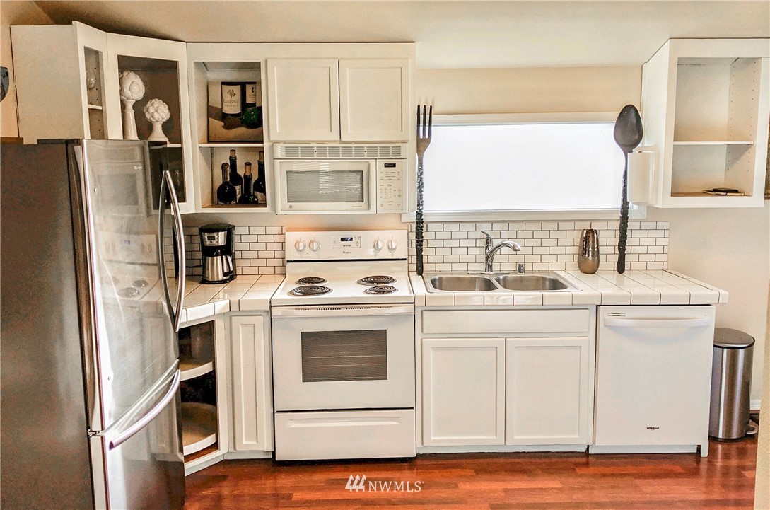 2212 Broadway Everett, WA 98201 - Photo 9 of 26 a kitchen with stainless steel appliances a white stove top oven and sink
