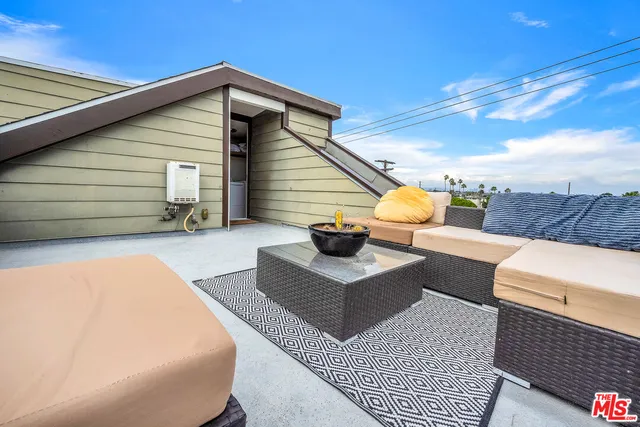 a view of a terrace with couches and sky view