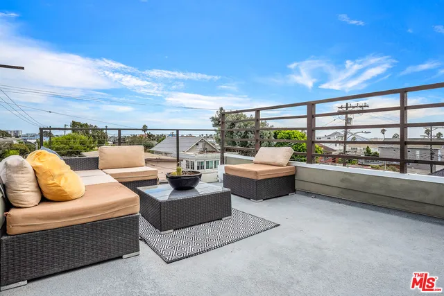 a balcony with furniture and city view