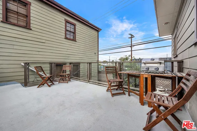 a view of a patio with a table and chairs