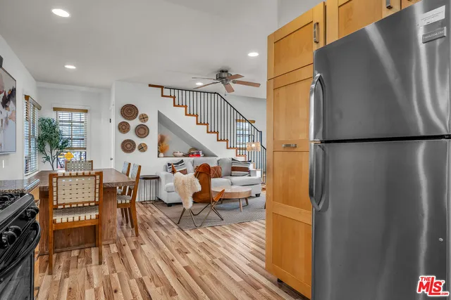 a view of kitchen with furniture and a refrigerator