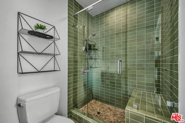 a bathroom with a toilet sink and shower