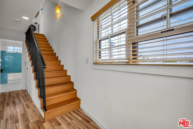 a view of entryway and hall with wooden floor